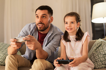 Image showing father and daughter playing video game at home