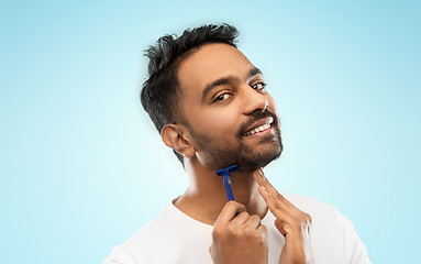 Image showing indian man shaving beard with razor blade