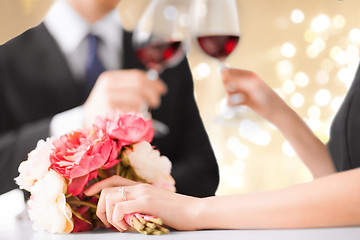 Image showing close up of engaged couple drinking red wine