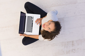 Image showing women using laptop computer on the floor top view