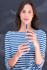 Image showing woman holding a internet cable in front of chalk drawing board