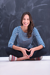 Image showing woman sitting in front of chalk drawing board