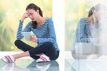 Image showing young women using tablet computer on the floor