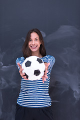 Image showing woman holding a soccer ball in front of chalk drawing board