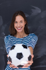 Image showing woman holding a soccer ball in front of chalk drawing board