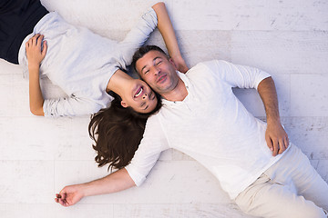 Image showing handsome couple lying on floor
