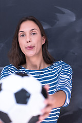 Image showing woman holding a soccer ball in front of chalk drawing board