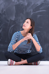 Image showing woman sitting in front of chalk drawing board