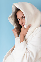 Image showing woman in a white coat with hood isolated on blue background