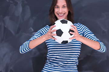 Image showing woman holding a soccer ball in front of chalk drawing board