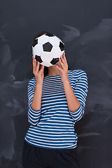 Image showing woman holding a soccer ball in front of chalk drawing board