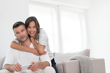 Image showing happy couple using mobile phone at home