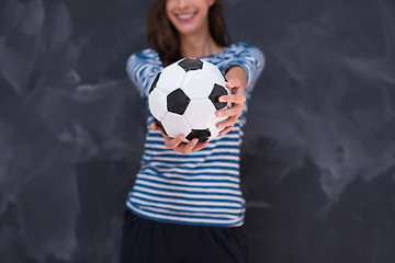 Image showing woman holding a soccer ball in front of chalk drawing board