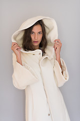 Image showing woman in a white coat with hood isolated on white background