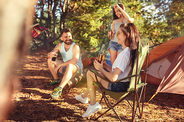 Image showing Party, camping of men and women group at forest. They relaxing