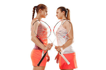 Image showing Young women badminton players posing over white background