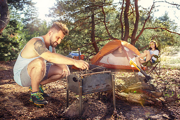 Image showing Party, camping of men and women group at forest. They relaxing