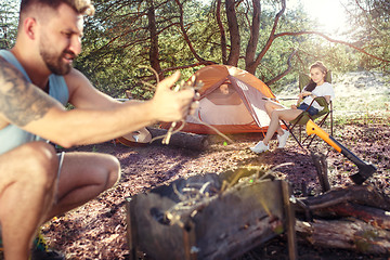 Image showing Party, camping of men and women group at forest. They relaxing