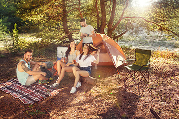 Image showing Party, camping of men and women group at forest. They relaxing