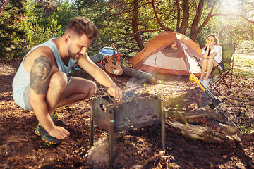 Image showing Party, camping of men and women group at forest. They relaxing