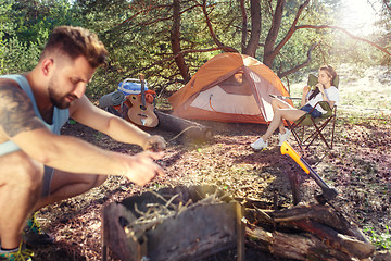 Image showing Party, camping of men and women group at forest. They relaxing