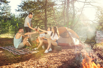 Image showing Party, camping of men and women group at forest. They relaxing