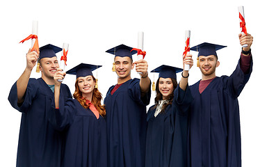 Image showing graduates in mortar boards with diplomas