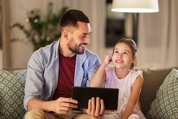 Image showing father and daughter listening to music on tablet