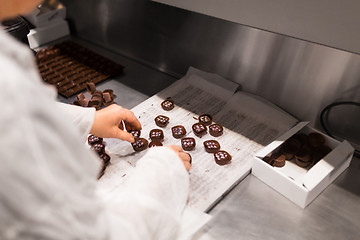 Image showing worker packing candies at confectionery shop