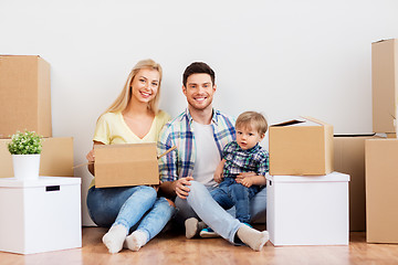 Image showing happy family with boxes moving to new home