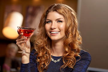 Image showing woman with glass of cocktail at night club