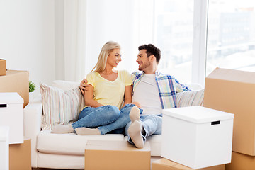 Image showing happy couple with boxes moving to new home