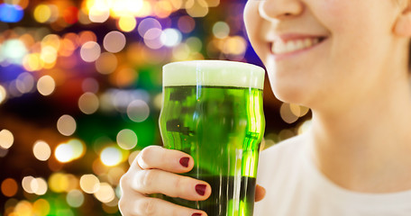 Image showing close up of woman with green beer in glass