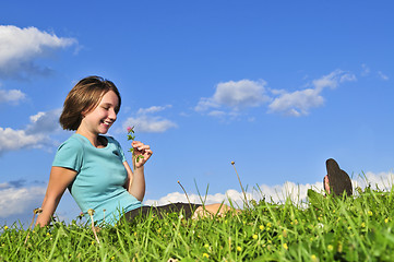 Image showing Young girl sitting on grass