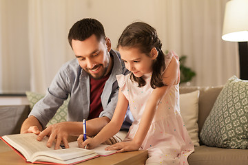 Image showing father and daughter doing homework together