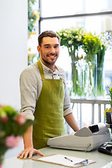 Image showing florist man or seller at flower shop counter