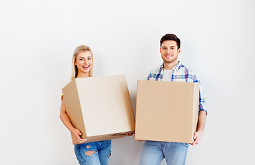 Image showing happy couple with boxes moving to new home