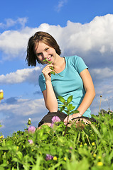 Image showing Young girl sitting on grass