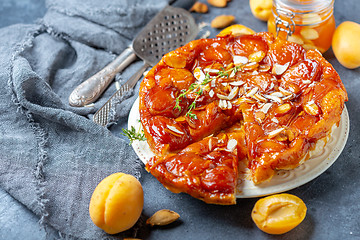 Image showing Apricot and almond tarte tatin on a white plate.