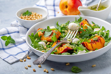 Image showing Fresh arugula salad with nectarines and pesto.