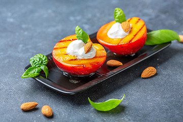 Image showing Grilled peach with honey, yogurt and almonds.