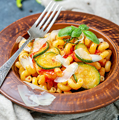 Image showing Pasta with tomato and zucchini sauce close-up.