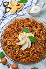 Image showing Pear crumble with a sprig of mint.