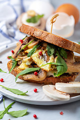 Image showing Sandwich with omelet, greens and mushrooms close-up.