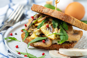 Image showing Slices of toasted bread with egg and mushrooms.