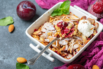 Image showing Red plum crumble with crunchy oatmeal and almond.