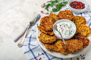 Image showing Zucchini pancakes and yogurt sauce for breakfast.