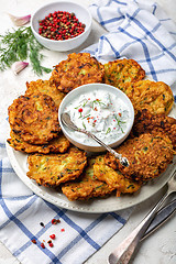 Image showing Zucchini fritters with yogurt sauce for breakfast.