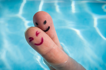 Image showing Happy finger couple for a hug in swimming pool