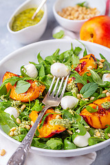 Image showing Salad with arugula, nectarines and pesto sauce.